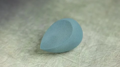 Sponge for makeup - rotates on a beautiful background. Cosmetics, makeup. Stock Footage 130346467