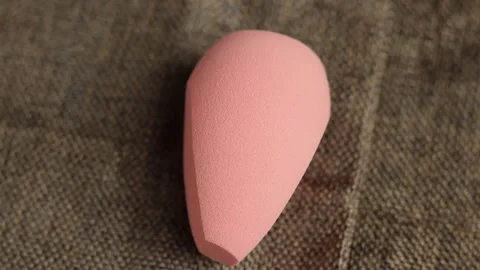 Sponge for makeup - rotates on a beautiful background. Cosmetics, makeup. Stock Footage 130346522
