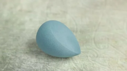 Sponge for makeup - rotates on a beautiful background. Cosmetics, makeup. Stock Footage 130346529