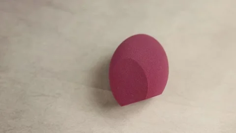 Sponge for makeup - rotates on a beautiful background. Cosmetics, makeup. Stock Footage 130346543