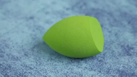 Sponge for makeup - rotates on a beautiful background. Cosmetics, makeup. Stock Footage 130346560