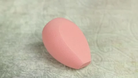 Sponge for makeup - rotates on a beautiful background. Cosmetics, makeup. Stock Footage 130346571