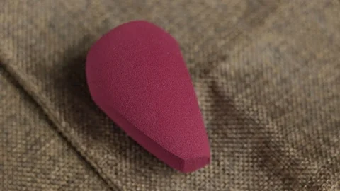 Sponge for makeup - rotates on a beautiful background. Cosmetics, makeup. Stock Footage 130346585