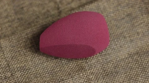 Sponge for makeup - rotates on a beautiful background. Cosmetics, makeup. Stock Footage 130346587