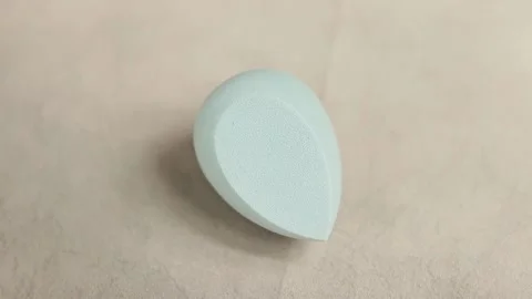 Sponge for makeup - rotates on a beautiful background. Cosmetics, makeup. Stock Footage 130346594