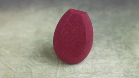 Sponge for makeup - rotates on a beautiful background. Cosmetics, makeup. Stock Footage 130346673