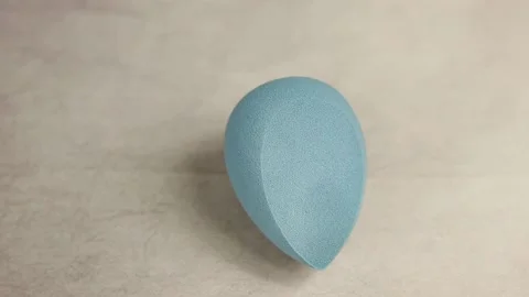 Sponge for makeup - rotates on a beautiful background. Cosmetics, makeup. Stock Footage 130346691