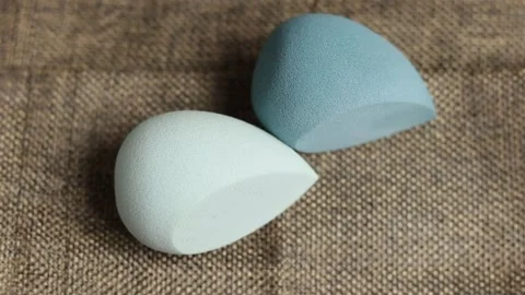 Sponge for makeup - rotates on a beautiful background. Cosmetics, makeup. Stock Footage 130346710