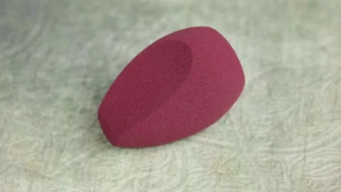 Sponge for makeup - rotates on a beautiful background. Cosmetics, makeup. Stock Footage 130346779