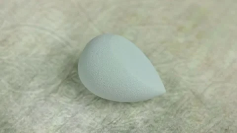 Sponge for makeup - rotates on a beautiful background. Cosmetics, makeup. Stock Footage 130346783