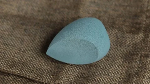 Sponge for makeup - rotates on a beautiful background. Cosmetics, makeup. Stock Footage 130346795