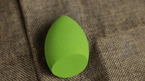 Sponge for makeup - rotates on a beautiful background. Cosmetics, makeup. Stock Footage 130346807