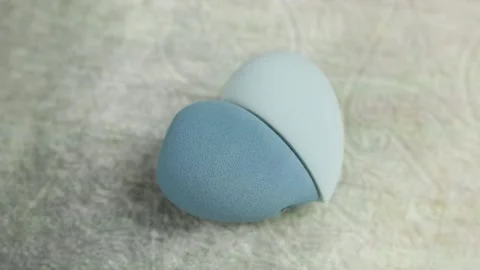 Sponge for makeup - rotates on a beautiful background. Cosmetics, makeup. Stock Footage 130346868