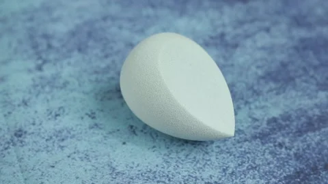 Sponge for makeup - rotates on a beautiful background. Cosmetics, makeup. Stock Footage 130346925