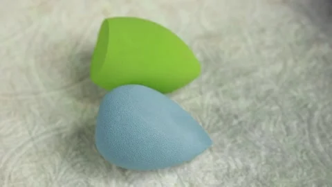 Sponge for makeup - rotates on a beautiful background. Cosmetics, makeup. Stock Footage 130346996