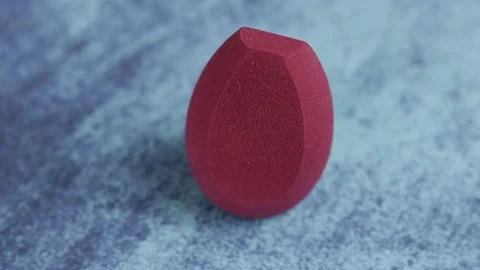 Sponge for makeup - rotates on a beautiful background. Cosmetics, makeup. Stock Footage 130347020