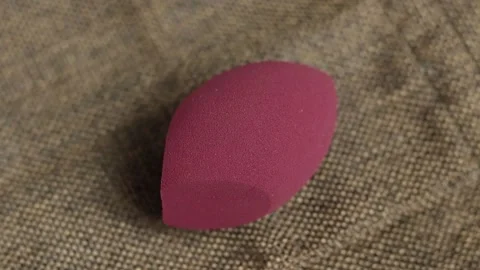 Sponge for makeup - rotates on a beautiful background. Cosmetics, makeup. Stock Footage 130347077