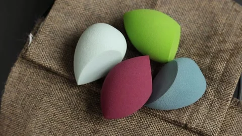 Sponge for makeup - rotates on a beautiful background. Cosmetics, makeup. Stock Footage 130347093