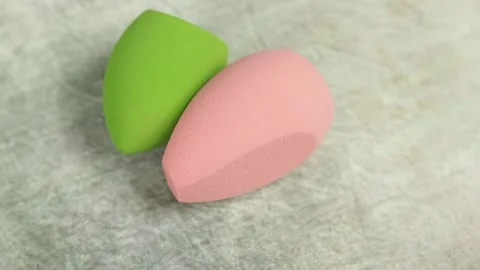 Sponge for makeup - rotates on a beautiful background. Cosmetics, makeup. Stock Footage 130347097