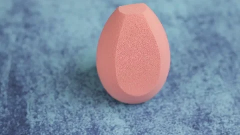 Sponge for makeup - rotates on a beautiful background. Cosmetics, makeup. Stock Footage 130347112