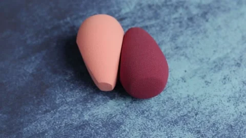 Sponge for makeup - rotates on a beautiful background. Cosmetics, makeup. Stock Footage 130347163