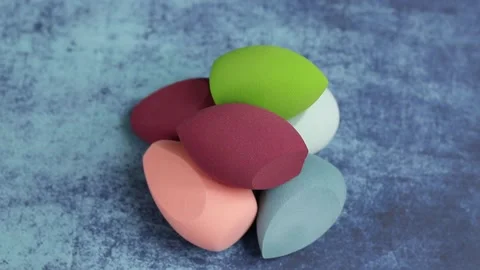 Sponge for makeup - rotates on a beautiful background. Cosmetics, makeup. Stock Footage 130347337