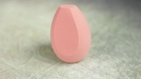 Sponge for makeup - rotates on a beautiful background. Cosmetics, makeup. Stock Footage 130347365
