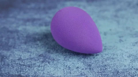 Sponge for makeup - rotates on a beautiful background. Cosmetics, makeup. Stock Footage 130347409