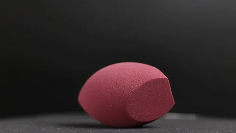 Sponge for makeup. Sponge for makeup on a black background. Stock Footage 129696590
