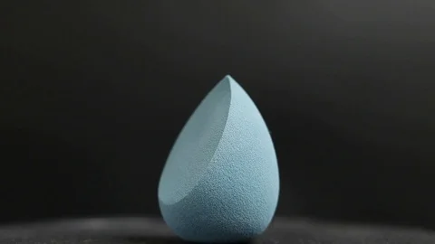 Sponge for makeup. Sponge for makeup on a black background. Stock Footage 129696747