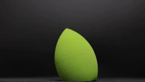 Sponge for makeup. Sponge for makeup on a black background. Stock Footage 129697144