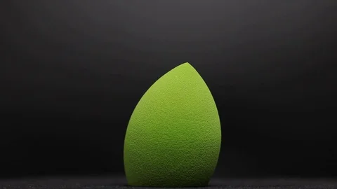 Sponge for makeup. Sponge for makeup on a black background. Stock Footage 129697165