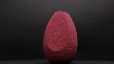 Sponge for makeup. Sponge for makeup on a black background. Stock Footage 129697313