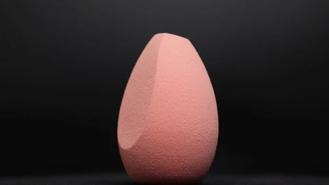 Sponge for makeup. Sponge for makeup on a black background. Stock Footage 129697483