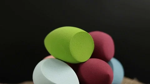 Sponge for makeup. Sponge for makeup on a black background. Stock Footage 129697506