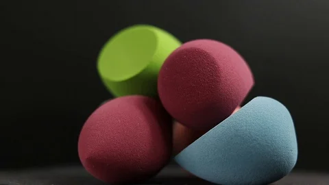 Sponge for makeup. Sponge for makeup on a black background. Stock Footage 129697544