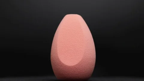 Sponge for makeup. Sponge for makeup on a black background. Stock Footage 129697561