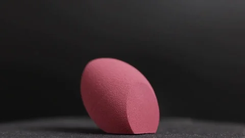 Sponge for makeup. Sponge for makeup on a black background. Stock Footage 129697718