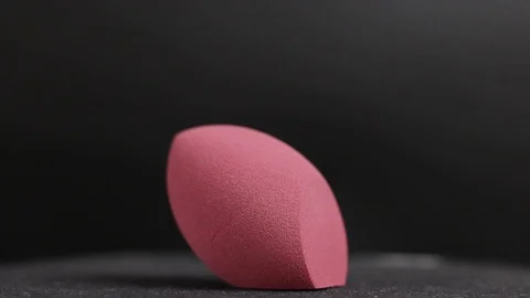 Sponge for makeup. Sponge for makeup on a black background. Stock Footage 129697747