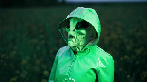 Spooky alien walking in field. Scary footage of arrived on planet Earth green Video stock 196109573