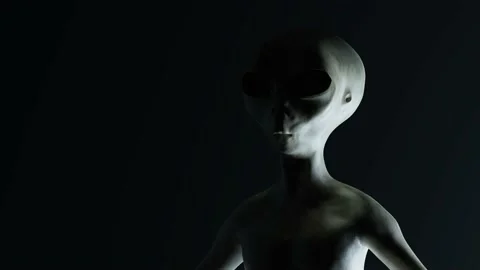 Spooky alien's face on black background. UFO and extraterrestrial life concept. Stock Footage 144573102