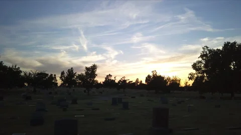 Spooky and haunted view of Cemetery during golden hour. Silhouette. Drone Stock Footage 221225838