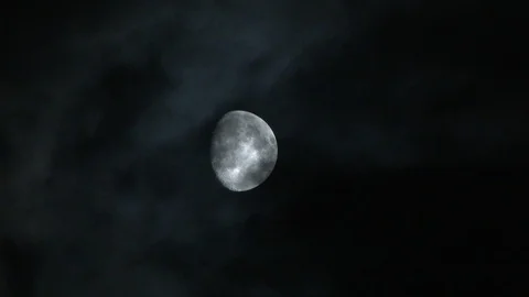 Spooky atmosphere of clouds passing across the face of a 3/4 moon, 4K. Stock Footage 85471468