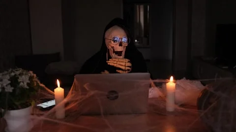 Spooky character of death, skeleton in black hood, dark background. Video stock 249640468