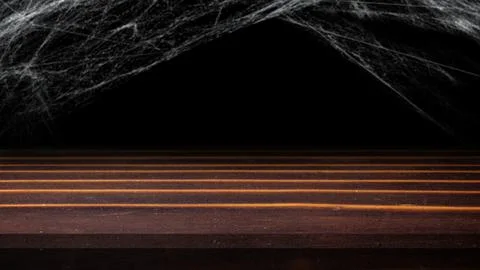 A spooky, dark, rustic wooden surface with realistic cobwebs hanging overhe.. Stock Photos