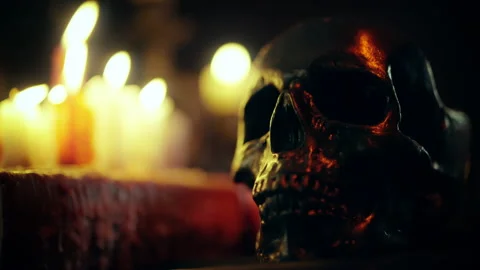 Spooky dark skull standing on table surrounded by burning candles, witchcraft Vídeos de archivo 197992246