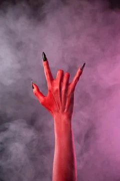 Spooky devil hand showing heavy metal gesture Stock Photos