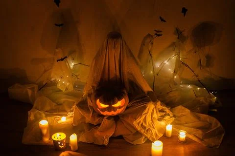 Spooky ghost holding Jack o lantern on background of spider web with bats a.. Stock-Fotos