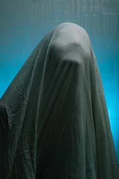 Spooky Ghost in a sheet on a blue background. Stock Photos