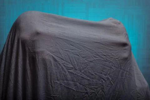 Spooky Ghost in a sheet with different faces on a blue background. Stock Photos